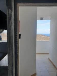 a door to a room with a view of the ocean at Océano Fuerte in Costa de Antigua