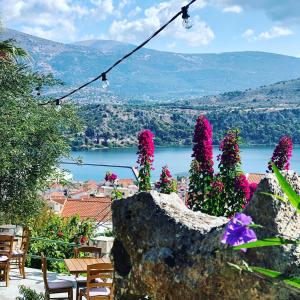 a view of a lake and flowers on a hill at Liostasi Retreat in Argostoli