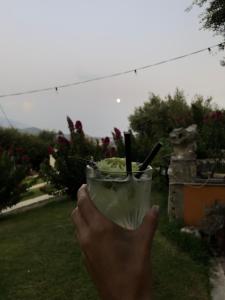 a person holding a drink in their hand at Liostasi Retreat in Argostoli