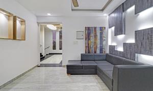 a living room with a couch and a hallway at Treebo Trend Kanopy Greens in Dehradun
