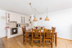 a kitchen and dining room with a wooden table and chairs at Mountain Charm in Kranjska Gora