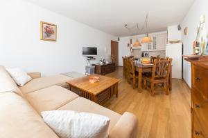 a living room with a couch and a table at Mountain Charm in Kranjska Gora