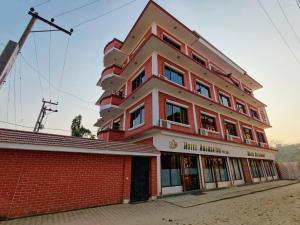a red and white building on a street at Hotel Ananda Inn in Lumbini