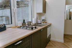 a kitchen with a stove top oven next to a window at Apartament Żeromskiego 1 in Sandomierz