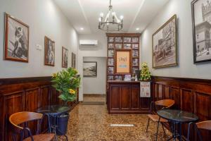 a restaurant with two tables and chairs in a room at Sans Hotel Empress Simpang Lima in Semarang