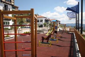 a playground with a slide and swings at HOTEL SPA MONTANA in Karpenisi