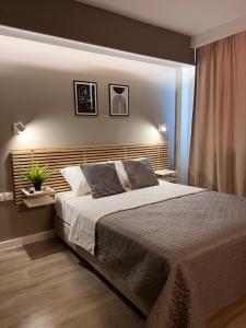 a bedroom with a large bed with two pillows at Luxor Premium Suites in Thessaloniki