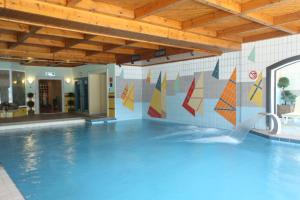 a swimming pool with a water slide in a building at HOTEL SPA MONTANA in Karpenisi