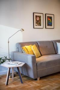 een woonkamer met een bank en een tafel bij Art & Comfort Home in Kaunas