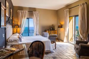 a hotel room with a bed and a balcony at Hotel Villa Carlotta in Taormina