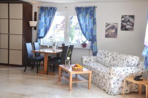a living room with a couch and a table at Hotel Mühleinsel in Kenzingen