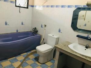 a bathroom with a tub and a toilet and a sink at Araliya hotel in Gampaha +35 photos