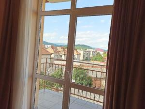 an open window with a view of a city at Beautiful Mountain View Apartment in Mukacheve