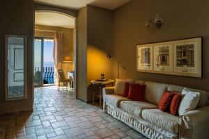 a living room with a couch and a view of the ocean at Hotel Villa Carlotta in Taormina