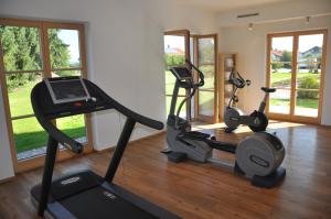a gym with two treadmills and two exercise bikes at Hotel Gasthof Moosleitner in Freilassing