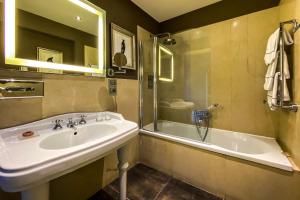 a bathroom with a sink and a shower and a tub at Hotel Villa Carlotta in Taormina