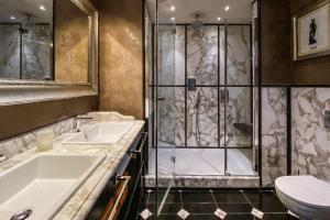 a bathroom with two sinks and a shower at Hotel Villa Carlotta in Taormina