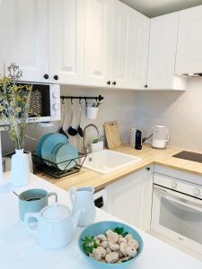 a kitchen with white cabinets and a plate of food on a counter at StayMenorca Redescubre la paz in Son Parc