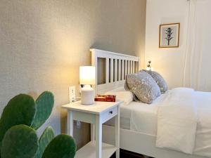 a bedroom with a bed and a table with a cactus at StayMenorca Redescubre la paz in Son Parc