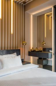 a bedroom with a bed and a desk with a mirror at New Gudauri Atrium Ski and Dream Apartments in Gudauri