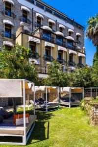 a row of beds in front of a building at Hotel Villa Carlotta in Taormina
