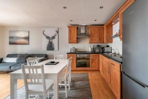 a kitchen and living room with a table and chairs at amazing apartments - Cables Wynd near The Shore - Free Parking in Edinburgh
