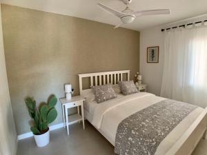 a bedroom with a bed and a ceiling fan at StayMenorca Redescubre la paz in Son Parc