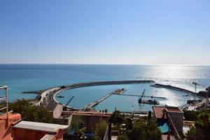 a large swimming pool in the middle of the ocean at Attico d' amare in Ventimiglia