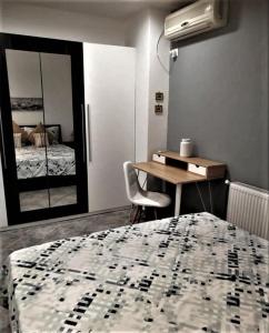 a bedroom with a bed and a table and a desk at Aphrodite Studio near Athens Floisvos Marina in Athens
