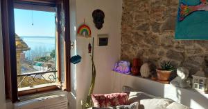 a room with a window with a view of the ocean at I Colori del Lago in Passignano sul Trasimeno