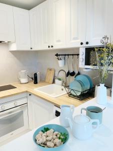 a kitchen with white cabinets and a bowl of food on a counter at StayMenorca Escapa a la naturaleza in Son Parc