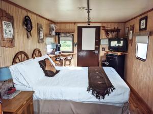 a bedroom with a bed and a television in it at Olympic Railway Inn in Sequim