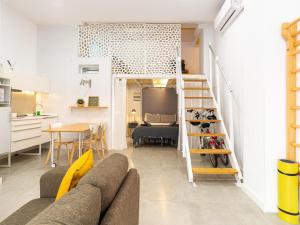 a living room with a couch and a dining room at LU&CIA LOFT City Center in Málaga