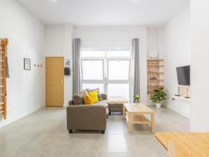 a living room with a couch and a table at LU&CIA LOFT City Center in Málaga