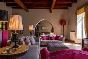 a living room with two couches and a table at Hotel Villa Carlotta in Taormina