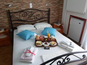 a bed with a tray of food on it at Villa Chrisanthi in Gera