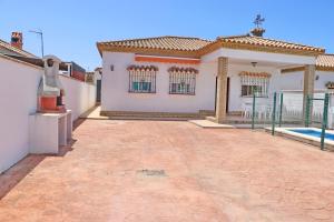 a large white house with a swimming pool at Chalet Pinar de Roche in Conil de la Frontera