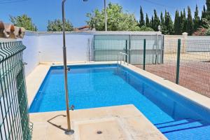 a swimming pool with a fence around it at Chalet Pinar de Roche in Conil de la Frontera