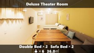 a room with a table and a bed and a couch at Vieuno Stay Hakata 2 in Fukuoka