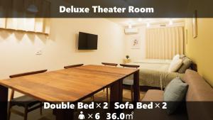 a room with a dining room table and a bed at Vieuno Stay Hakata 2 in Fukuoka