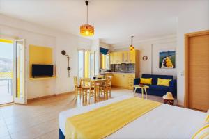 A television and/or entertainment centre at Aelia Apartments & Suites