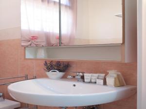 a white sink in a bathroom with a mirror at PRATO DELLA VALLE STUDIO in Padova