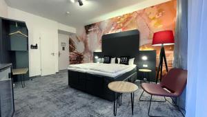 a bedroom with a bed and a table and chairs at SMARTY Cologne Dom Hotel - Boardinghouse - KONTAKTLOSER SELF CHECK-IN in Cologne +51 photos