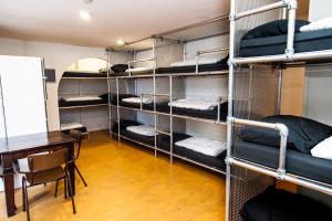a room with several bunk beds and a desk at Jorplace Boutique Hostel in Scheveningen