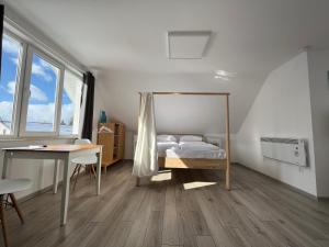 a bedroom with a bed and a desk and window at Pixel Guesthouse in Tîrgu Secuiesc