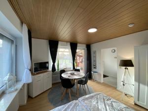 a bedroom with a bed and a table and chairs at Haus Sternenstrand Tossens in Butjadingen OT Tossens