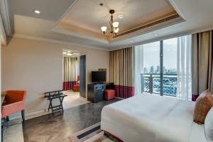 a hotel room with a bed and a large window at Arjaan by Rotana - Dubai Media City in Dubai