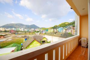 a balcony with a view of a city at Nanai 2 Residence Patong Phuket in Patong Beach