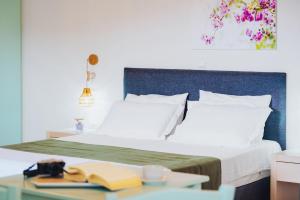 A bed or beds in a room at Aelia Apartments & Suites