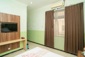 Televiisor ja/või meelelahutuskeskus majutusasutuses Urbanview Hotel de Kopen Malang by RedDoorz